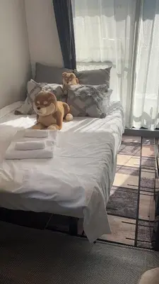 two stuffed animals sitting on top of a bed at Sky house\u6674\u7a7a\u5854\u89c2\u666f\u9633\u53f0-03 in Tokyo