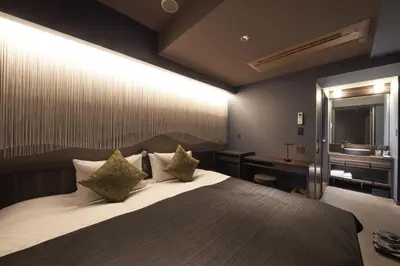 a bedroom with a large bed and a sink at SAKE Bar Hotel Asakusa in Tokyo