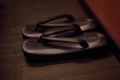 a pair of sandals sitting on a wooden floor at SAKE Bar Hotel Asakusa in Tokyo