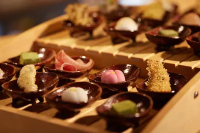a bunch of chocolate dishes in a tray on a table at SAKE Bar Hotel Asakusa in Tokyo