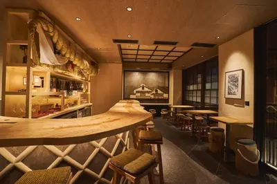 a bar in a restaurant with tables and stools at SAKE Bar Hotel Asakusa in Tokyo