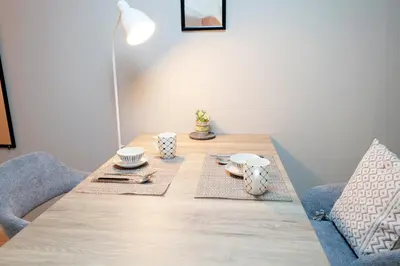 a wooden table with plates and cups on it at \u5922\u306e\u820e \u65b0\u5bbf Yumenoya Shinjuku in Tokyo