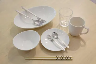 a table with white plates and forks and spoons at PALAIS GRACE 301 in Tokyo