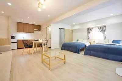 a hotel room with two beds and a kitchen at PALAIS GRACE 301 in Tokyo