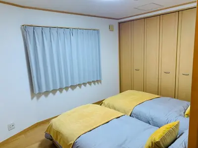 two beds sitting next to each other in a bedroom at Kamei House - Vacation STAY 07100v in Tokyo
