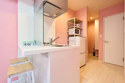a kitchen with a sink and a refrigerator at Shinjuku colorbee pretty house103 in Tokyo