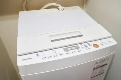 a white washer and dryer in a room at Shinjuku colorbee pretty house103 in Tokyo