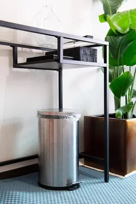 a metal table with a trash can under it at Shinjuku central apartment! 3stops to Shibuya station 3mins walk to station in Tokyo