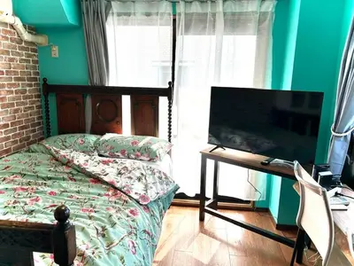 a bedroom with a bed and a flat screen tv at \u30e9\u30d5\u30a9\u30ec\uff11\uff10\uff11\u3000\u65b0\u5bbf\u304b\u308913\u5206\u306e\u304f\u3064\u308d\u3052\u308b\u304a\u90e8\u5c4b in Tokyo