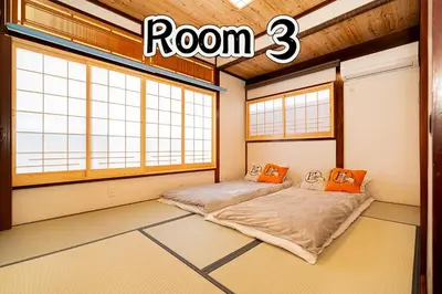 two beds in a room with two windows at TOKYO HOSHI VILLIA-Private Villa in Tokyo ideal for groups and families in Tokyo