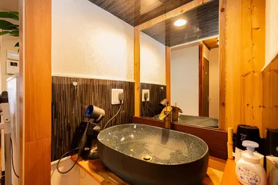a bathroom with a large black tub in front of a mirror at TOKYO HOSHI VILLIA-Private Villa in Tokyo ideal for groups and families in Tokyo
