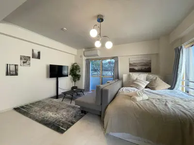 a bedroom with a bed and a couch and a tv at Oak Stay Shimokitazawa Luxury Family size 2min Shimokitazawa sta Shinjuku Shibuya7min by train in Tokyo