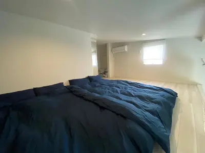 a bedroom with a blue bed with a window at Shibuya Stay Tokyo A204 in Tokyo