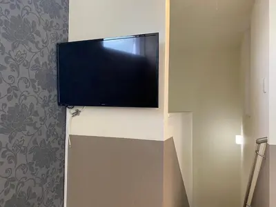 a flat screen tv on a wall in a room at Shibuya Stay Tokyo A204 in Tokyo
