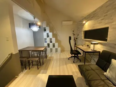 a living room with a couch and a desk and a table at Shibuya Stay Tokyo A204 in Tokyo