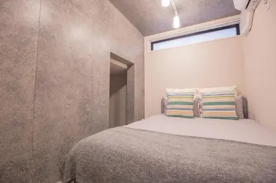 a small bedroom with a bed with a window at 2mins walk to Ueno station (Tokyo)-YoE9 in Tokyo