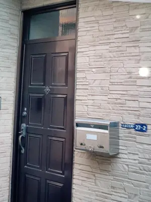 a door to a building with a pay phone next to it at \u6c60\u888b\u5feb\u901f\u4e00\u99c5kyoka house in Tokyo