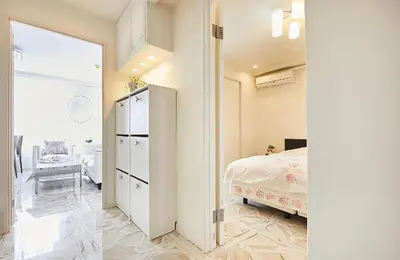 a bedroom with a bed and a room with a mirror at Reimi Mondo501 in Tokyo