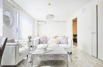 a white living room with a white couch and a table at Reimi Mondo501 in Tokyo
