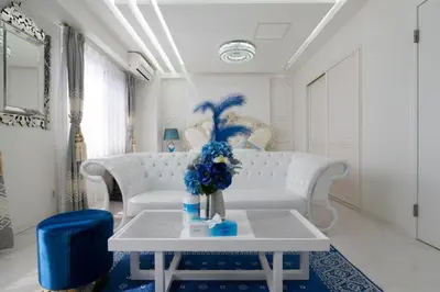 a living room with a white couch and a table with blue flowers at Reimi Mondo301 in Tokyo