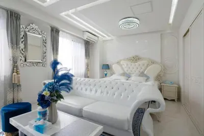 a white bedroom with a white couch and a table at Reimi Mondo301 in Tokyo