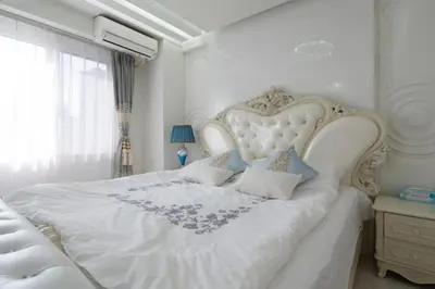 a white bed with a white headboard in a bedroom at Reimi Mondo301 in Tokyo