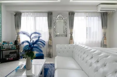 a white living room with a white couch and a table at Reimi Mondo301 in Tokyo