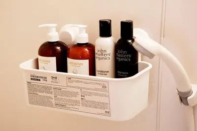 a hanging rack with bottles of hair products on a wall at #2 3stops to Shinjuku station stylish spacious studio apartment in Tokyo