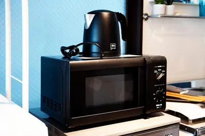 a coffee pot sitting on top of a microwave at #2 3stops to Shinjuku station stylish spacious studio apartment in Tokyo