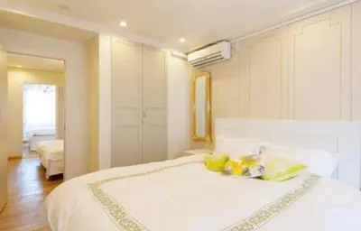 a bedroom with a large white bed with yellow pillows at Reimi Mondo401-7897 in Tokyo