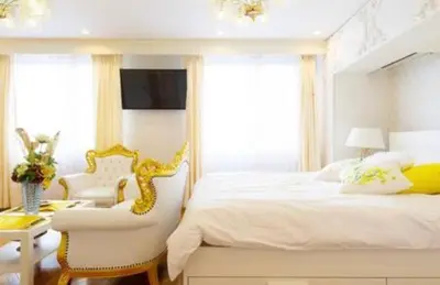 a bedroom with a white bed and a white chair at Reimi Mondo401-7897 in Tokyo