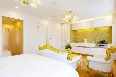 a white room with a bed and a kitchen at Reimi Mondo401-7897 in Tokyo