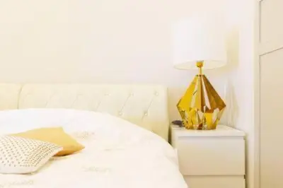a white bed with a lamp on a night stand at Reimi Mondo401-7897 in Tokyo