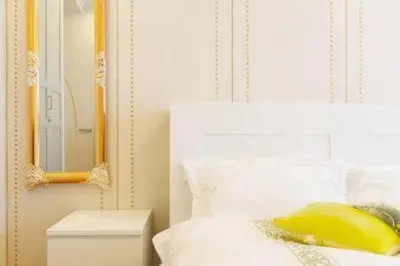 a bedroom with a white bed with a yellow pillow and a mirror at Reimi Mondo401-7897 in Tokyo