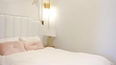 a bedroom with a white bed and a lamp at Reimi Mondo601 in Tokyo