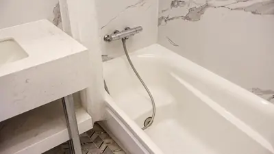 a white bathroom with a tub and a sink at Reimi Mondo601 in Tokyo