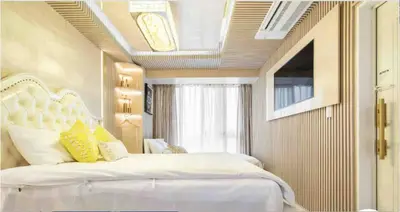 a bedroom with a large white bed with yellow pillows at Reimi Mondo702 in Tokyo