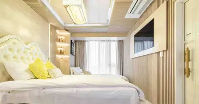 a bedroom with a large white bed with yellow pillows at Reimi Mondo702 in Tokyo
