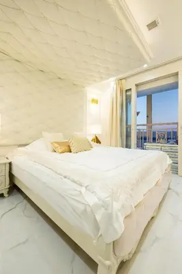 a white bedroom with a large bed with a window at Reimi Mondo602 in Tokyo