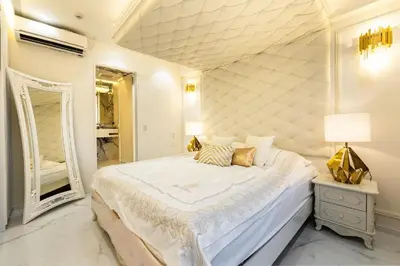 a white bedroom with a large bed and a mirror at Reimi Mondo602 in Tokyo
