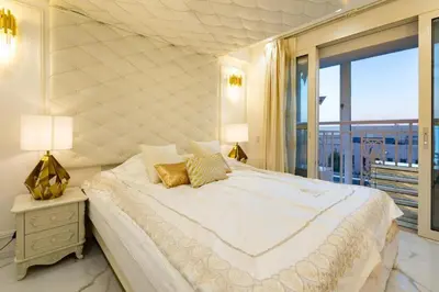 a white bedroom with a large bed and a balcony at Reimi Mondo602 in Tokyo