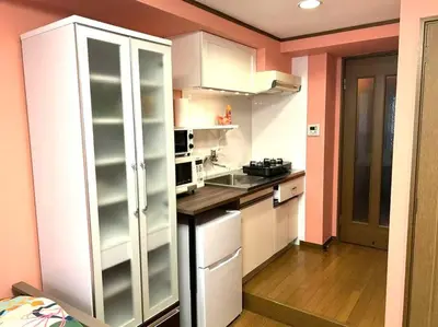 a kitchen with white cabinets and a counter top at \u30e9\u30d5\u30a9\u30ec\uff11\uff10\uff12\u3000\u65b0\u5bbf\u304b\u308913\u5206\u306e\u304f\u3064\u308d\u3052\u308b\u304a\u90e8\u5c4b in Tokyo
