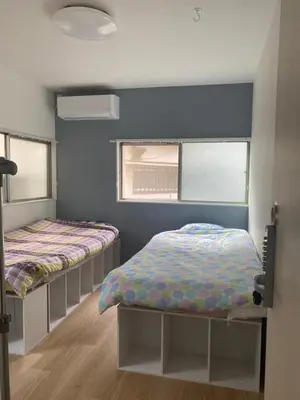 a bedroom with two beds and a window at Tokyo Skytree Tower\u30fbAsakusa Ashiana Guest House in Tokyo