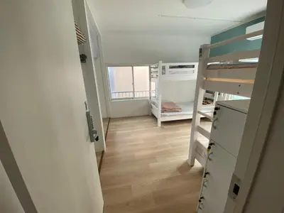 a small room with a bunk bed and a ladder at Tokyo Skytree Tower\u30fbAsakusa Ashiana Guest House in Tokyo