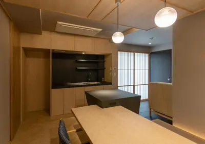 a kitchen with a wooden table and a counter top at \u30e2\u30c0\u30f3\u548c\u98a8\u6c11\u5bbf \u7c8bSui \u4e0a\u91ce Asakusa in Tokyo
