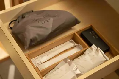 a wooden drawer with a pillow and papers in it at \u30e2\u30c0\u30f3\u548c\u98a8\u6c11\u5bbf \u7c8bSui \u4e0a\u91ce Asakusa in Tokyo