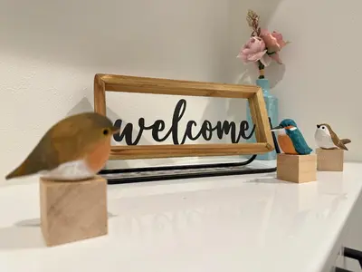 a table with a welcome sign and a bird on it at nestay villa tokyo sugamo in Tokyo