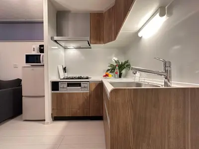 a kitchen with a sink and a refrigerator at nestay villa tokyo sugamo in Tokyo
