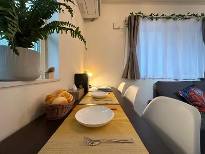 a dining room with a table with a bowl of fruit at nestay villa tokyo sugamo in Tokyo
