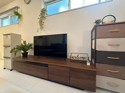 a living room with a flat screen tv on a wooden entertainment center at nestay villa tokyo sugamo in Tokyo